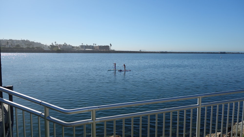 a couple of people on a paddle board in the water