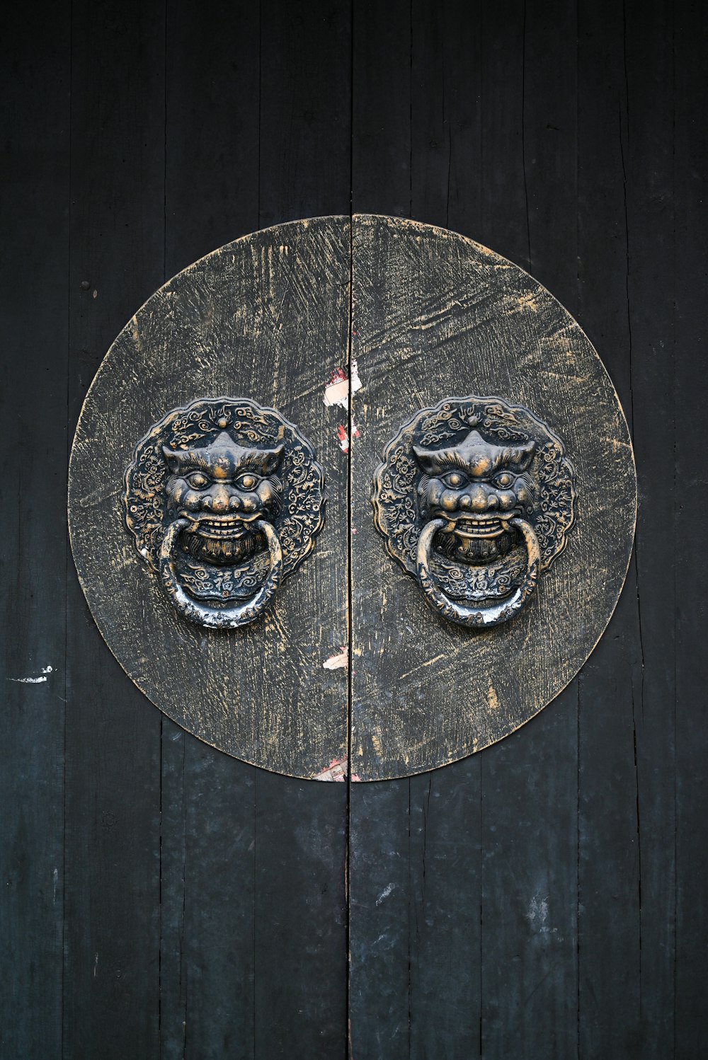 a close up of a wooden door with two metal handles