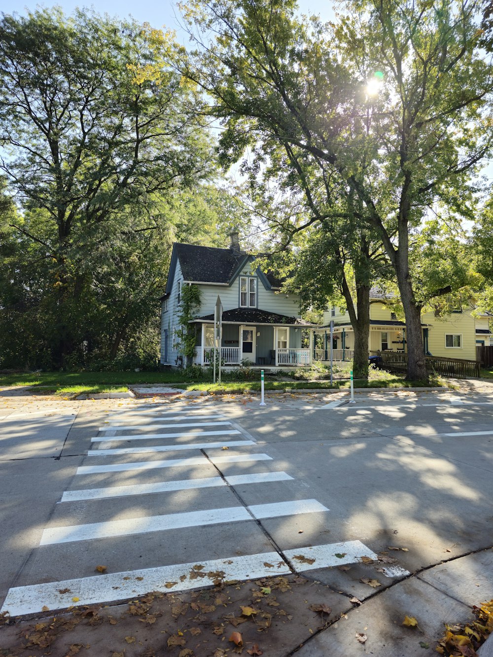 a white house sitting on the corner of a street