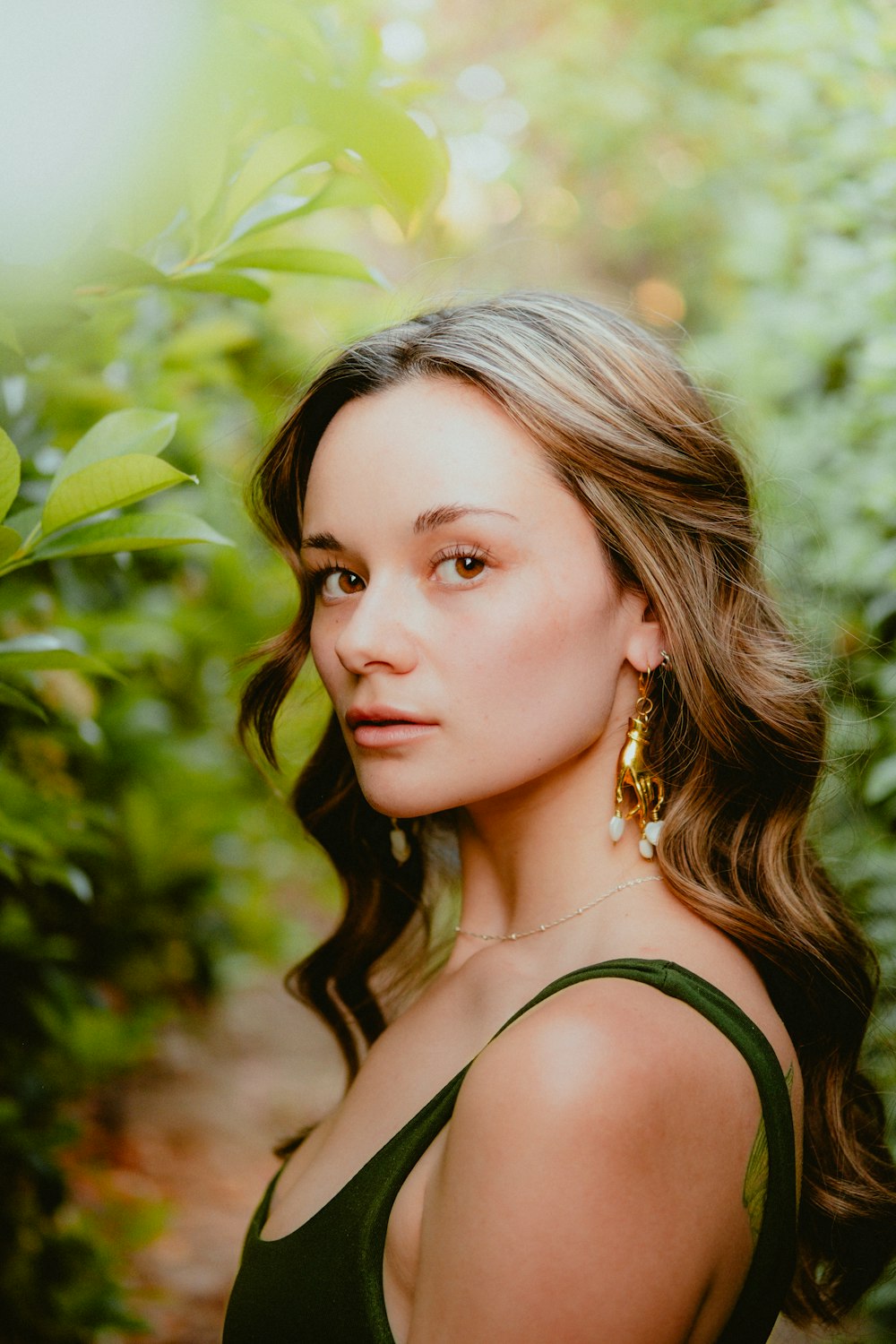 a woman in a green dress is posing for a picture