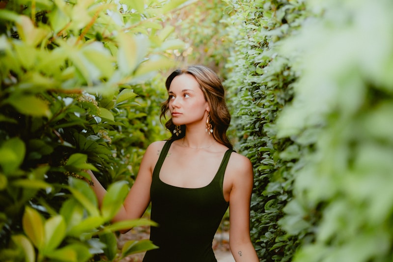 stunning woman in black dress among luxury landscaping
