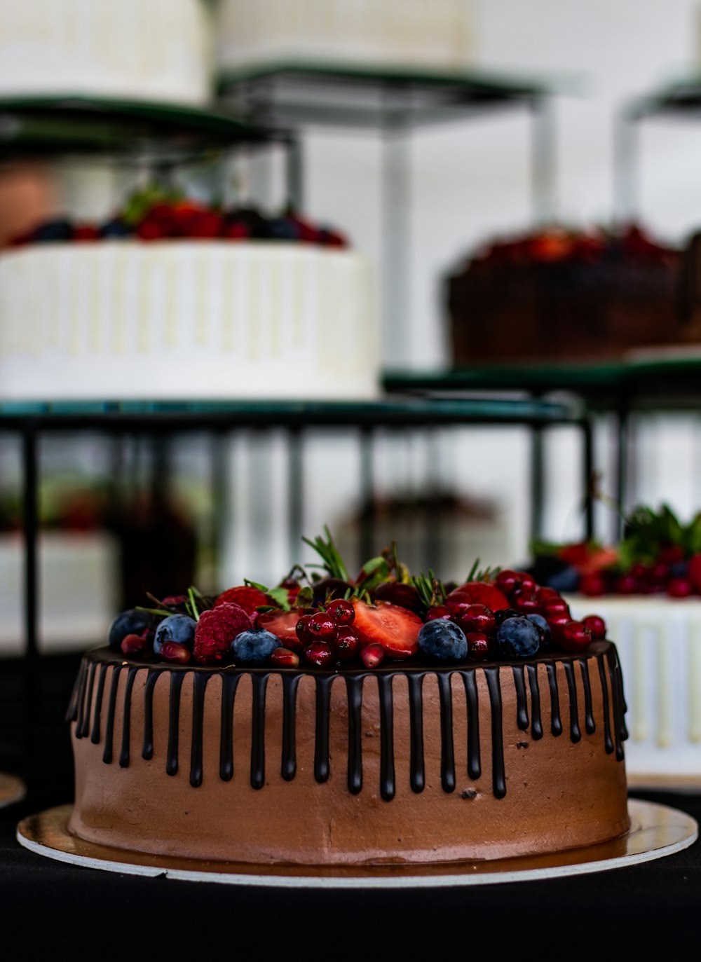 a chocolate cake topped with berries and chocolate icing