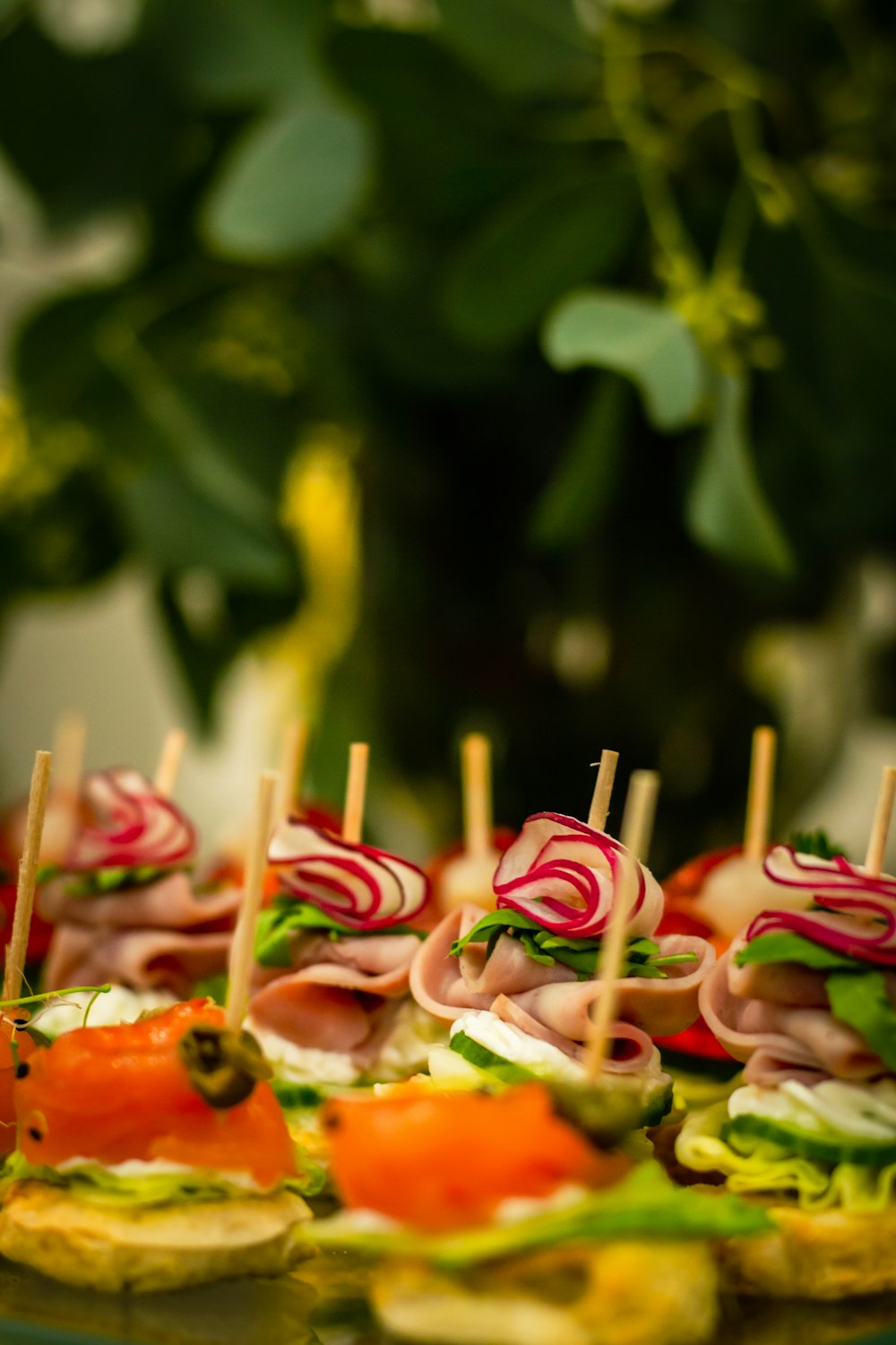 a platter of finger foods with toothpicks in the middle