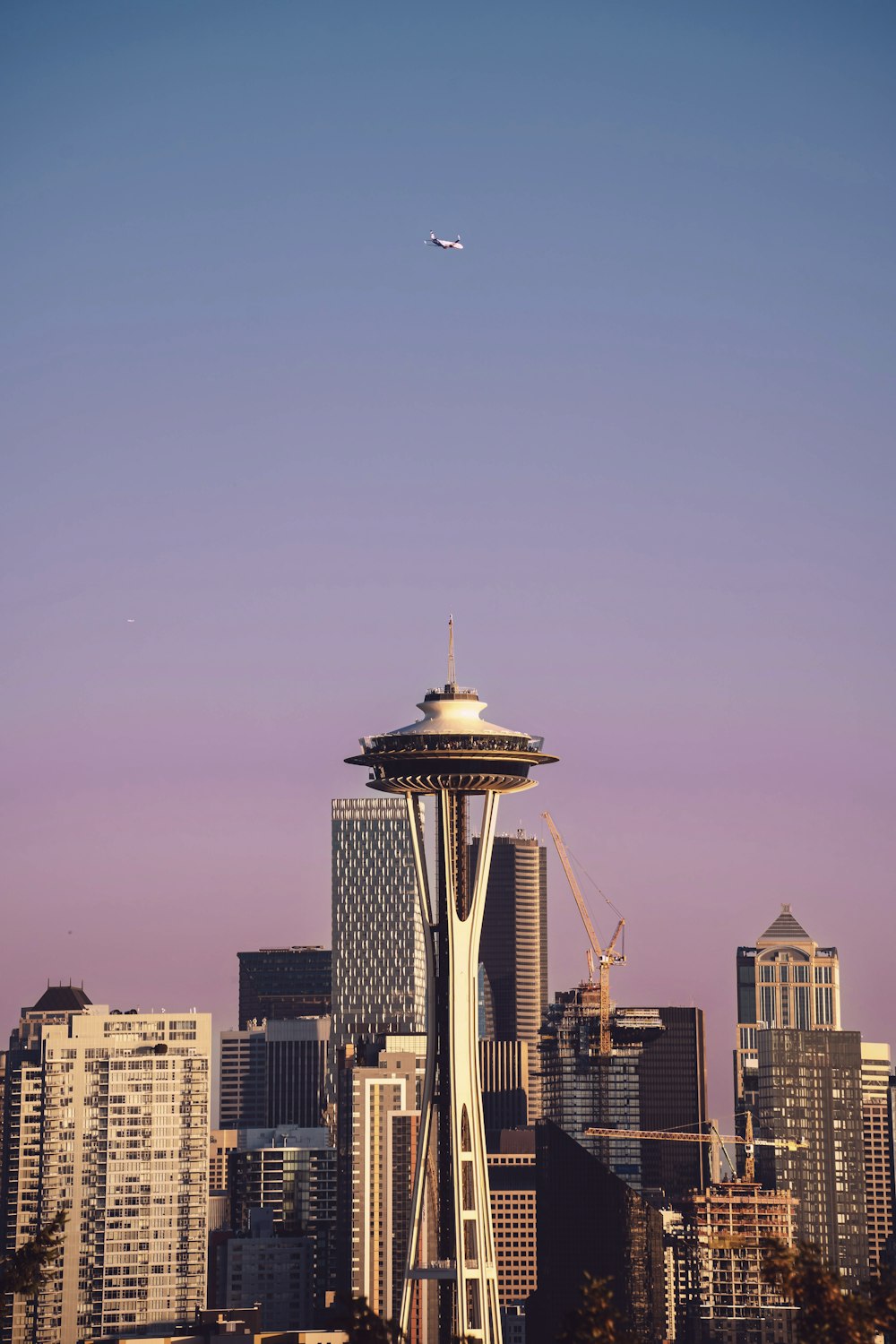 a tall tower with a plane flying over it