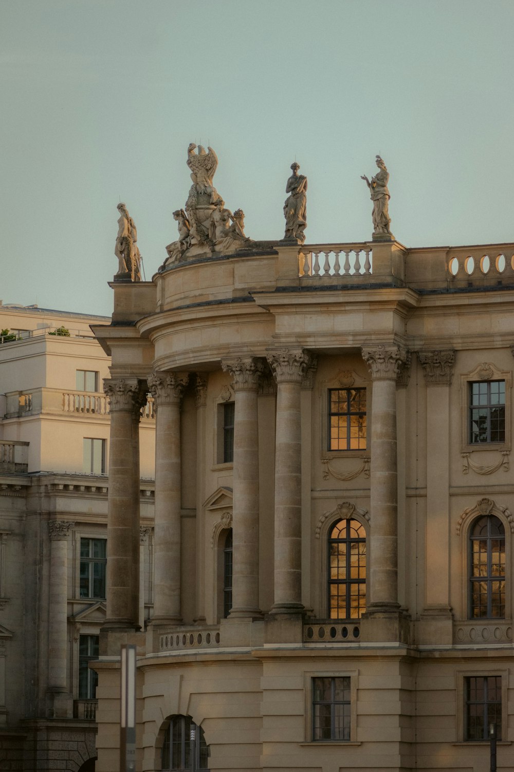 a large building with statues on top of it