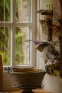 a basket sitting on top of a table next to a window