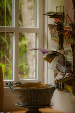 a basket sitting on top of a table next to a window
