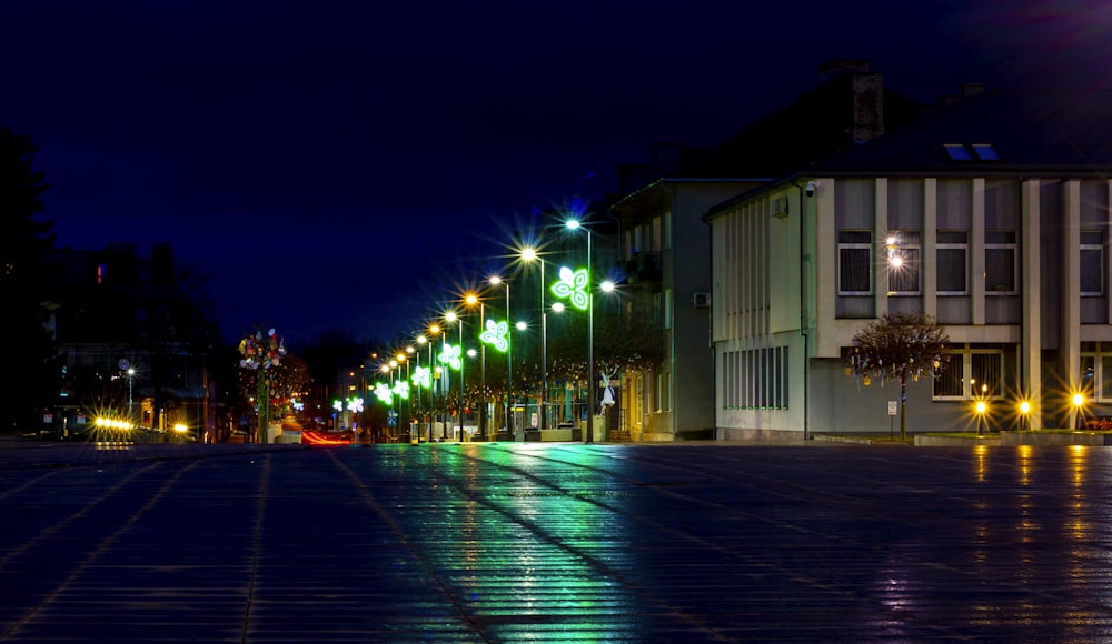 a city street at night with lights reflecting off the wet pavement