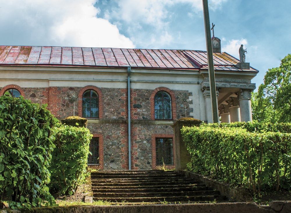 a building with a red tiled roof and a set of steps leading up to it