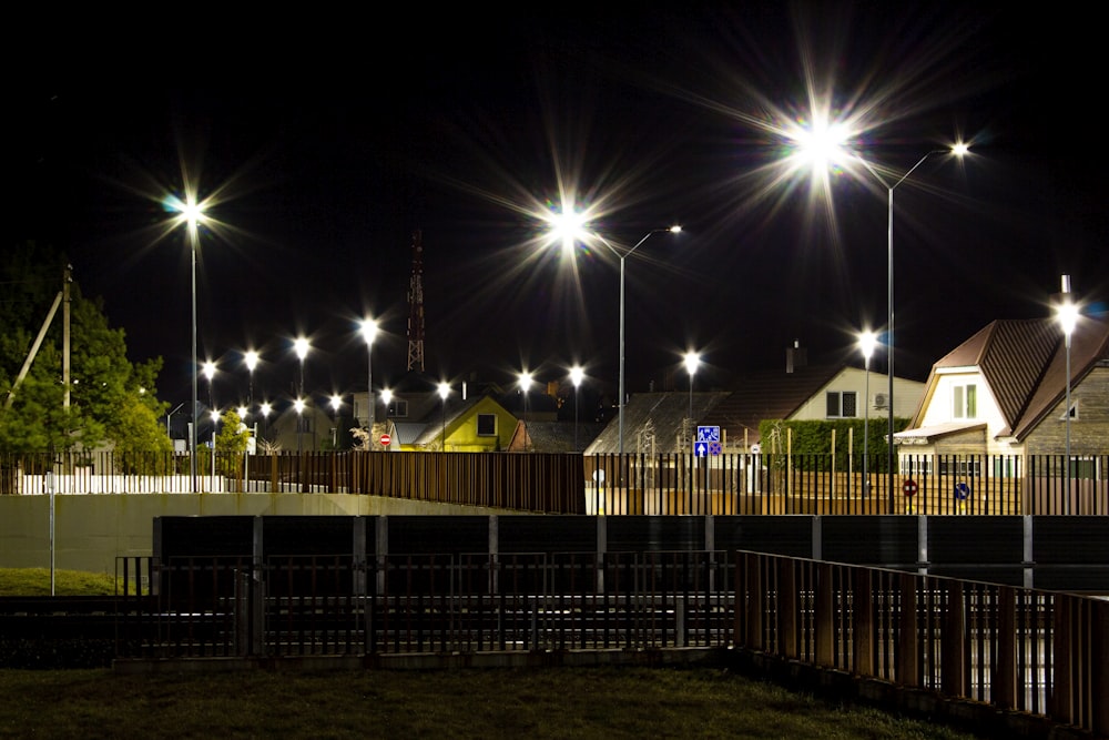 a row of street lights shine brightly at night