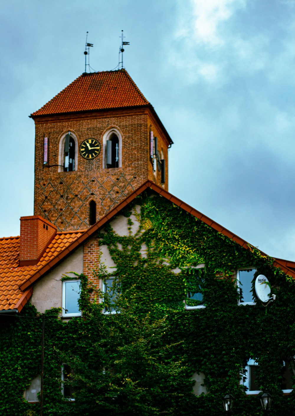 a tall brick building with a clock on it's side