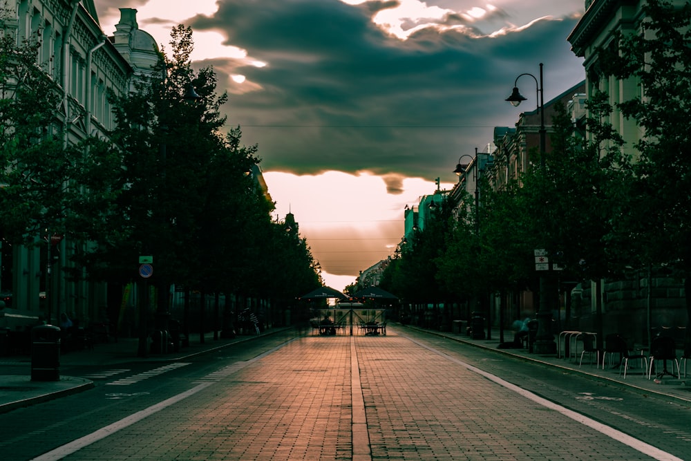 a street lined with tall buildings under a cloudy sky