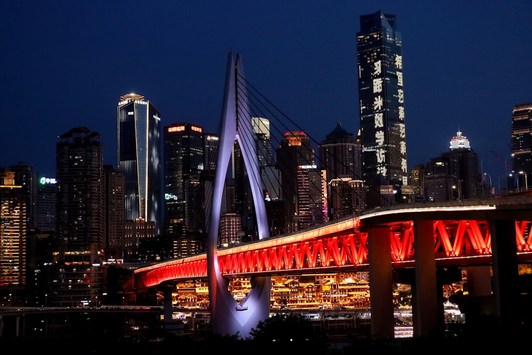 Hongya Cave's tiered stilt-house architecture illuminated at night, showing the layered wooden-style buildings with warm lights
