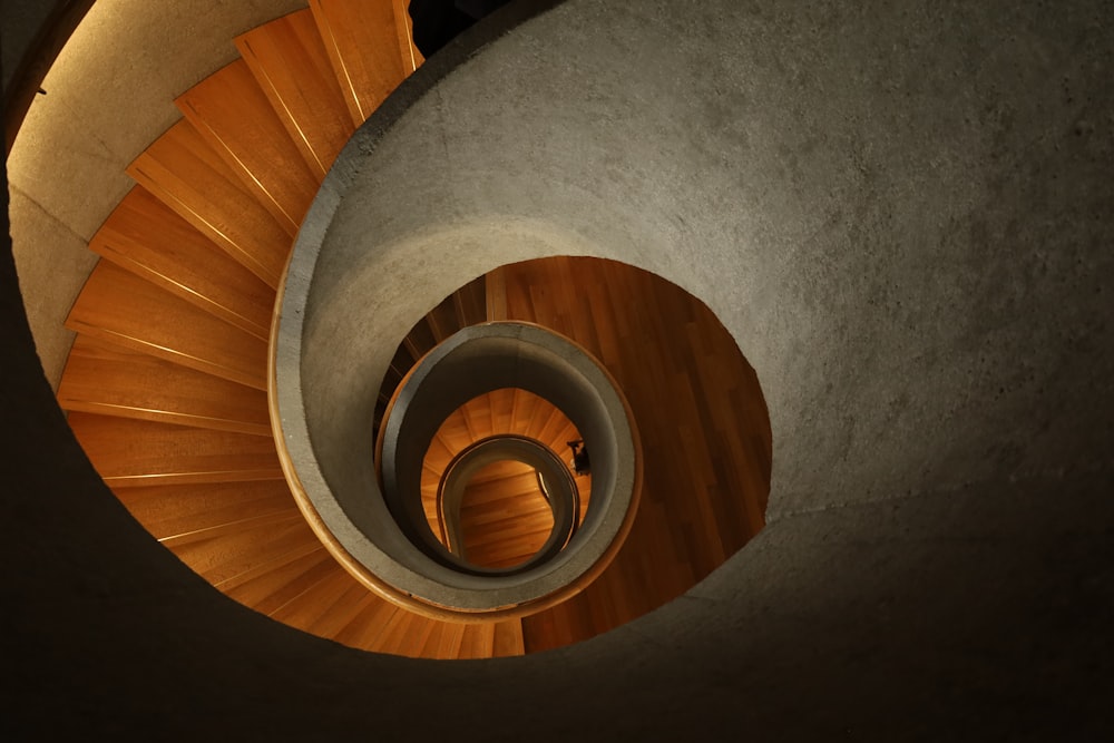 a spiral staircase with a person walking up it