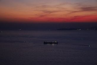 A vigilant security team patrolling a large cargo ship at dusk.
