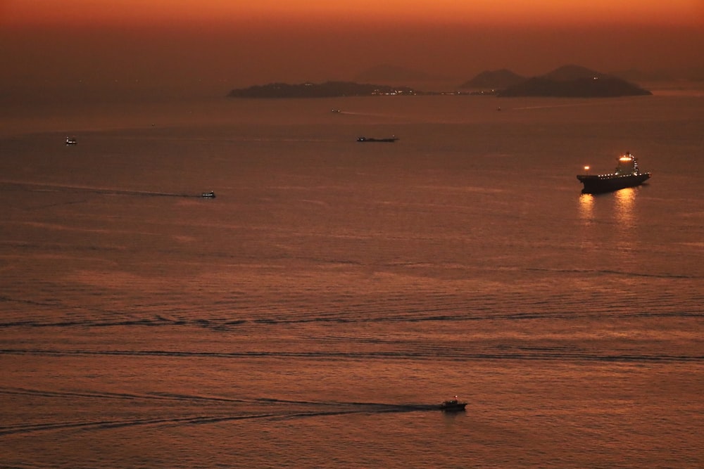 a boat is in the water at sunset