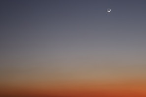 A serene gathering under a twilight sky painted in rich earth tones and shimmering gold accents.