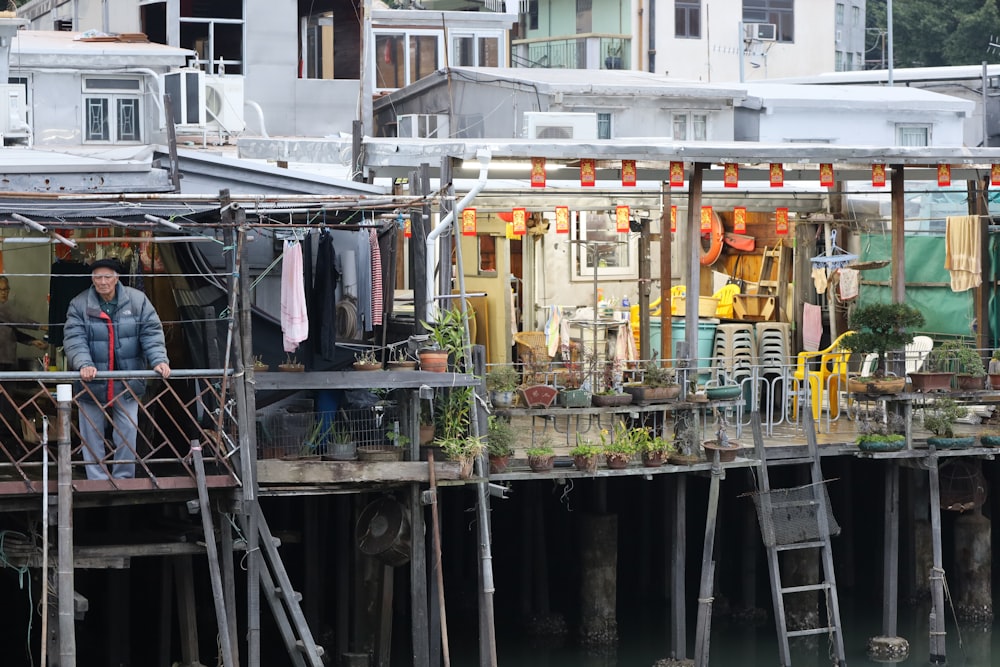 a man standing on a dock next to a building