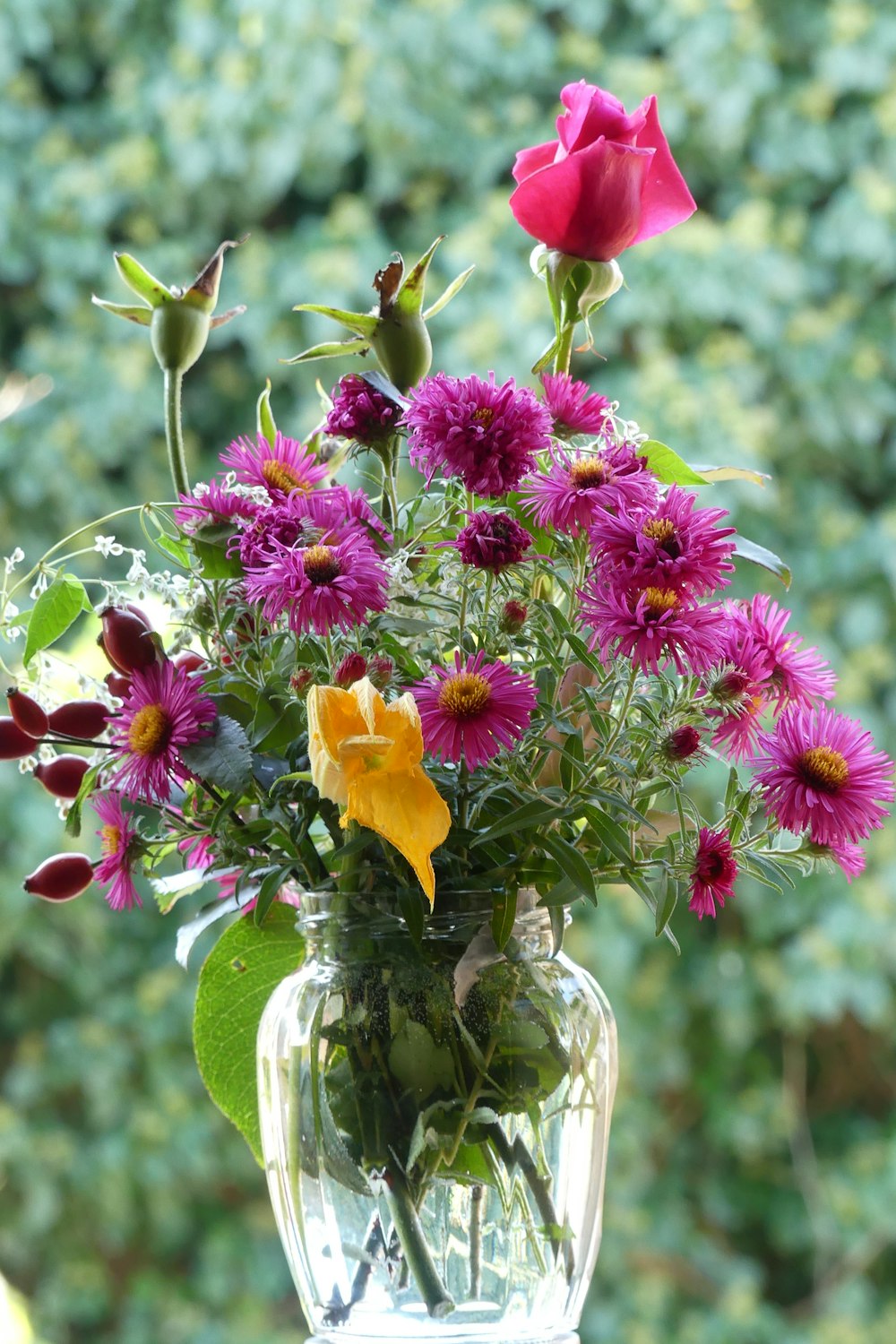 a vase filled with purple and yellow flowers