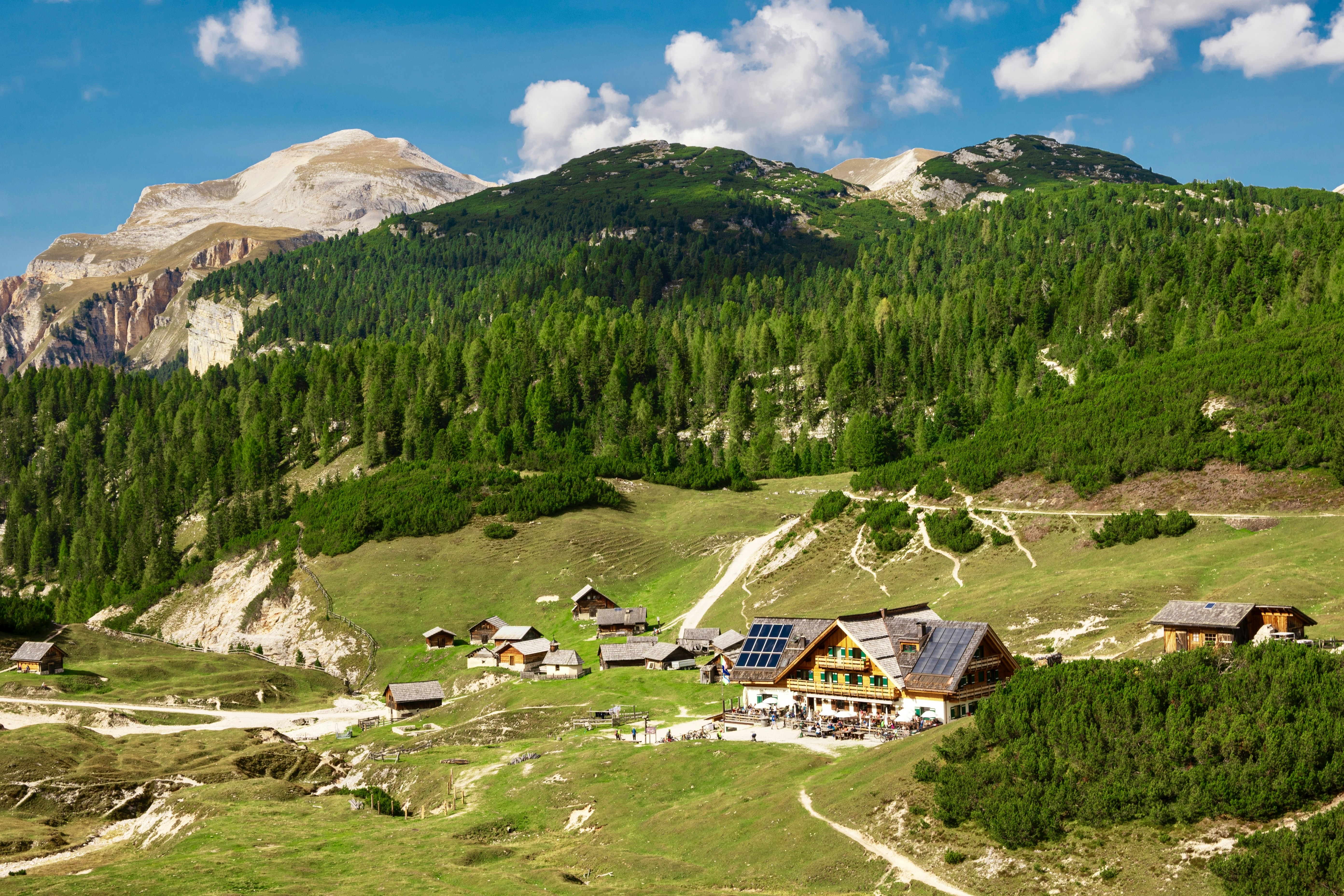 a small village in the mountains with a mountain in the background