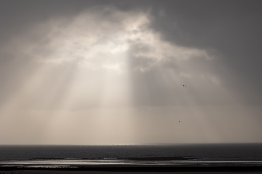 the sun shines through the clouds over the ocean