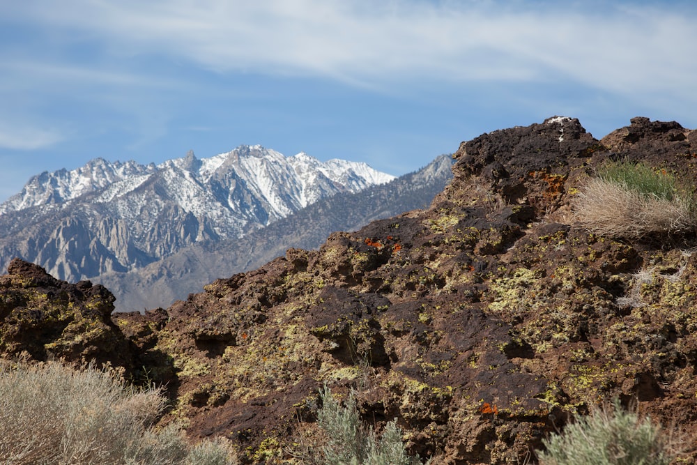 a mountain range with snow capped mountains in the background