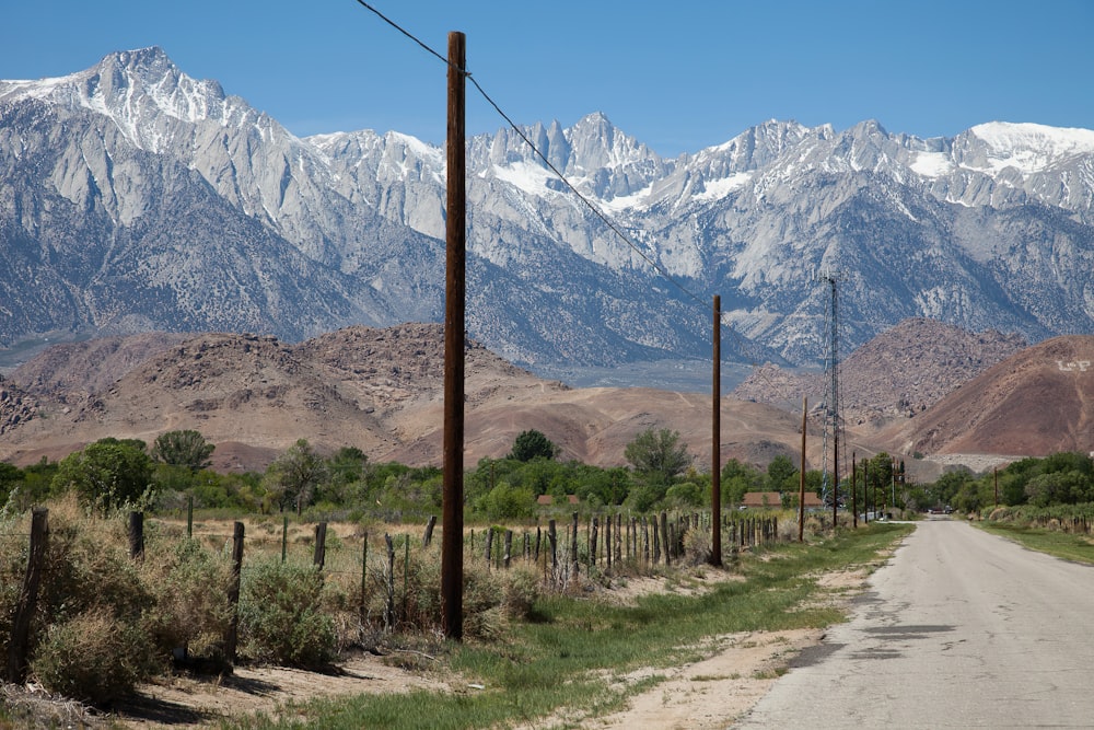 a dirt road with mountains in the background