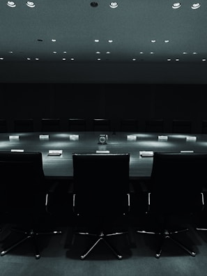 A shadowy committee meeting, representing the dark forces at play.
