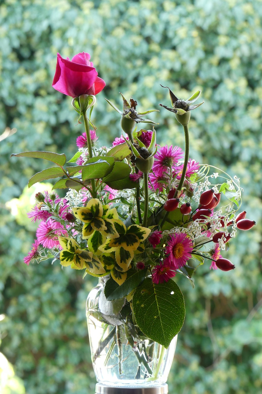 a vase filled with flowers sitting on top of a window sill