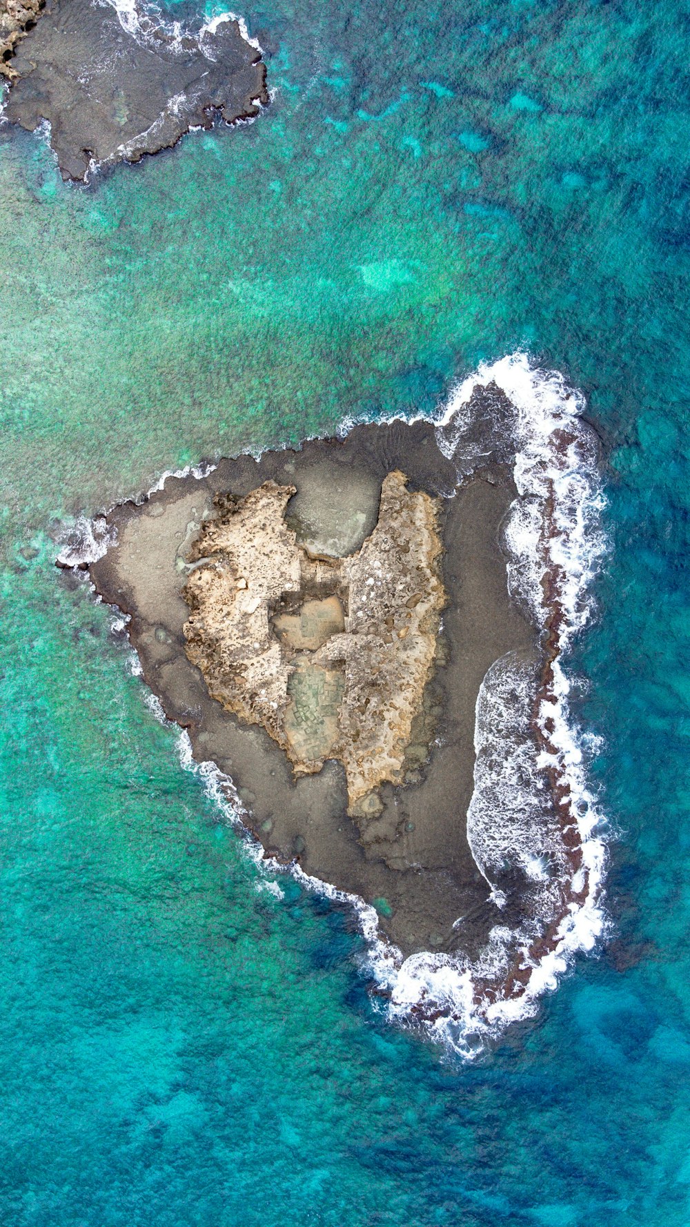 an aerial view of an island in the middle of the ocean