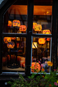 A vibrant display of decorative home items including candles, vases, and wall art.