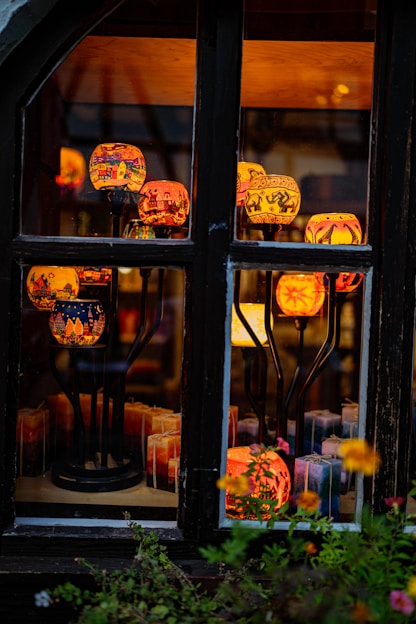 A warm, inviting artisan workspace showing handmade cement candle holders and candles in progress.