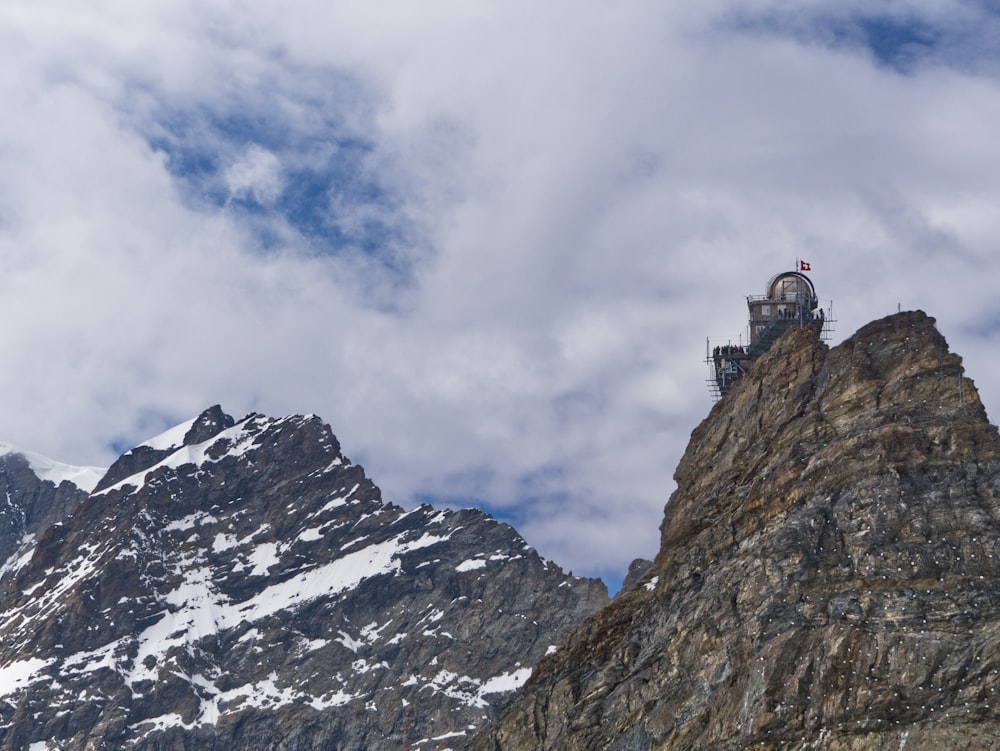 a tower on top of a mountain with a sky background