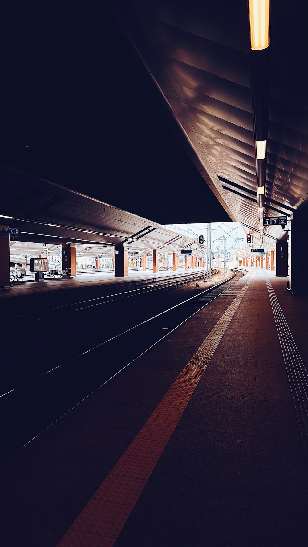 a train station with a train on the tracks