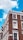 A corner of a brick building with multiple white-framed windows. The building features a classic architectural style with detailed cornices. A street sign on the building indicates 'Craven Road W2, City of Westminster.' The sky is a vibrant blue with a few white clouds.