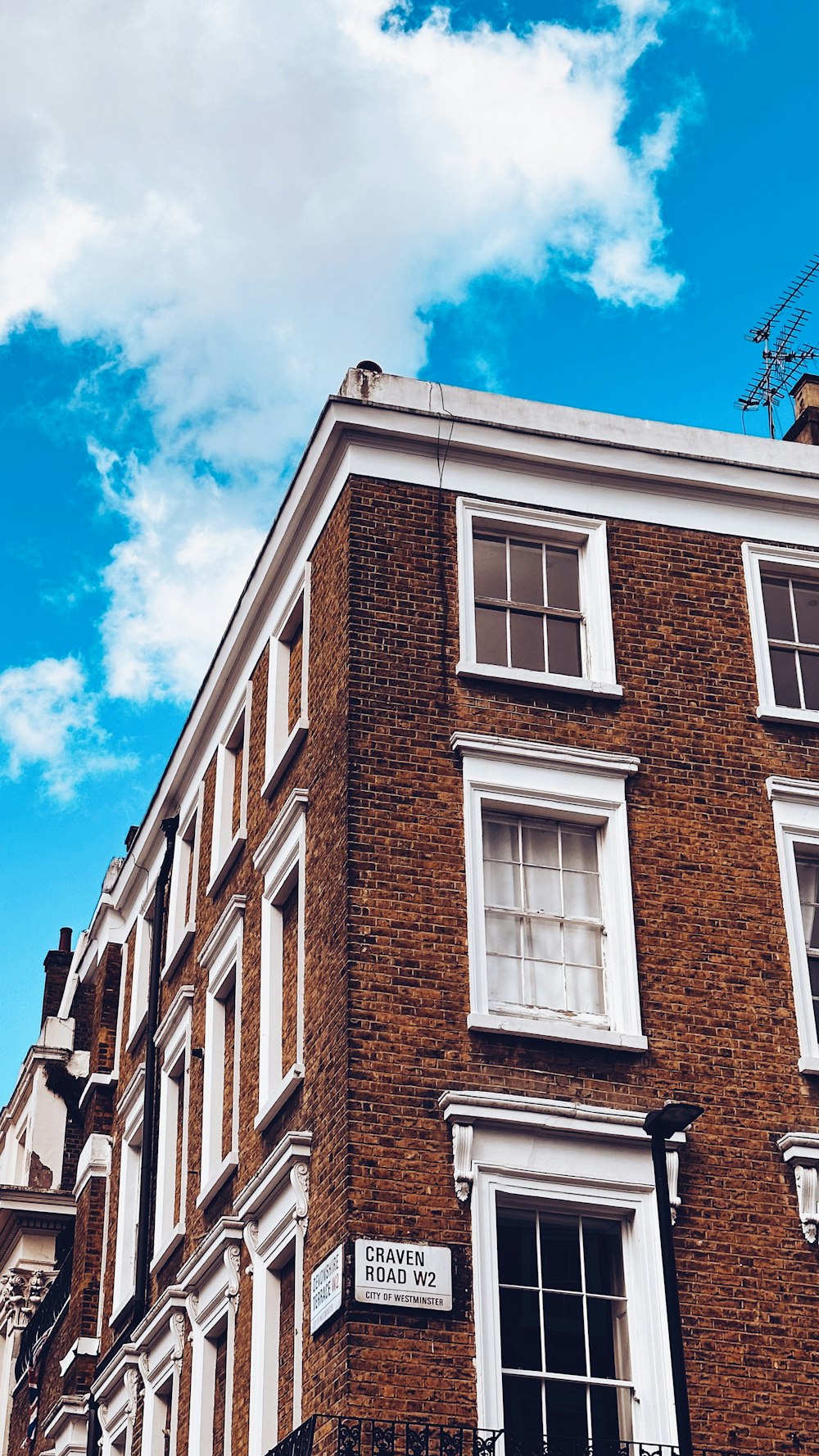 a tall brick building with a clock on the top of it