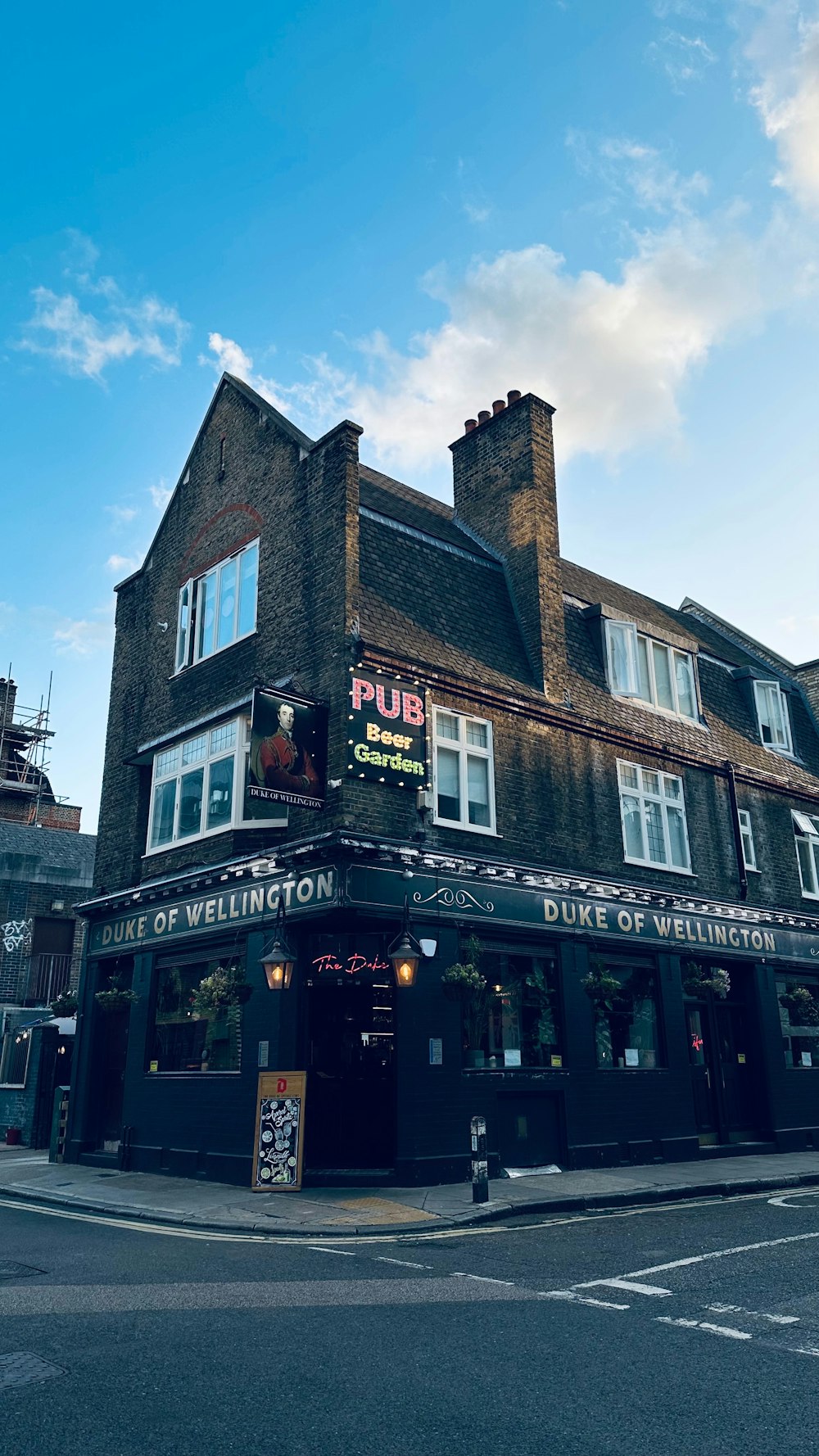 a pub on a street corner with a sky background