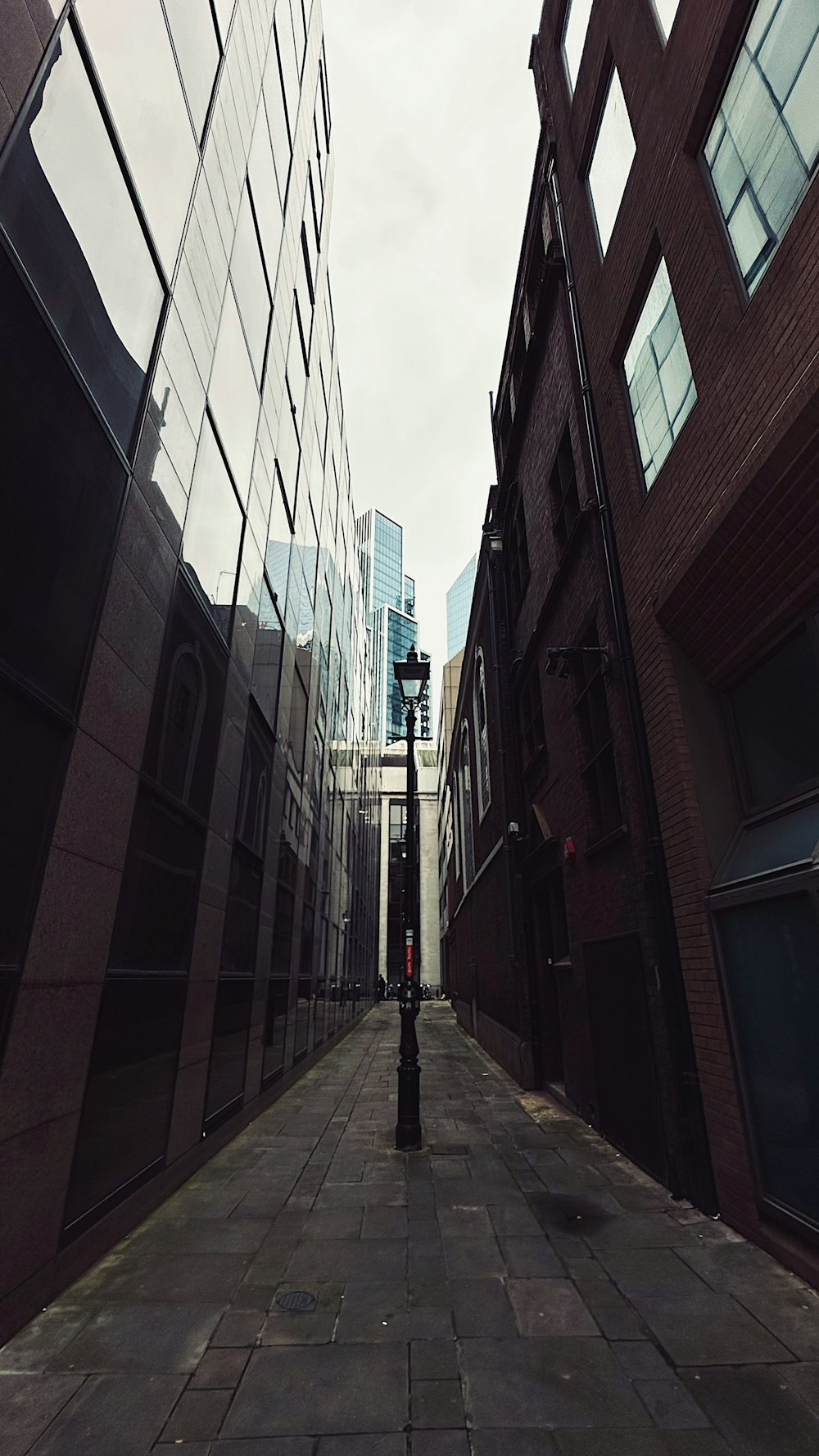 a narrow city street with tall buildings on both sides