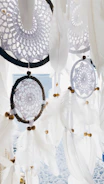 a group of white feathers hanging from a ceiling