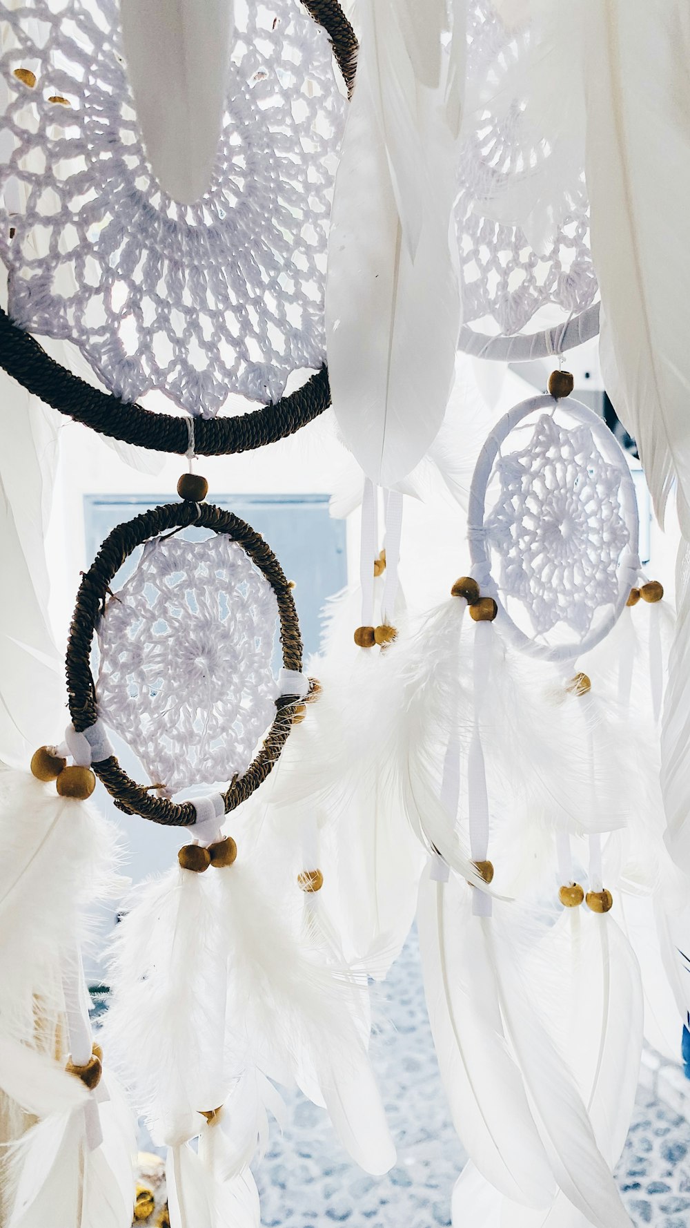 a group of white feathers hanging from a ceiling