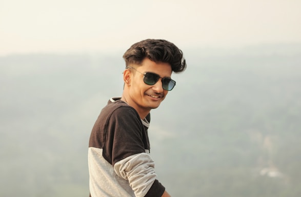 A friendly customer service representative wearing stylish sunglasses, smiling and ready to assist.