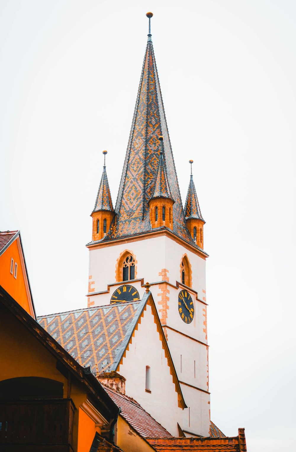 a tall clock tower with a clock on each of it's sides