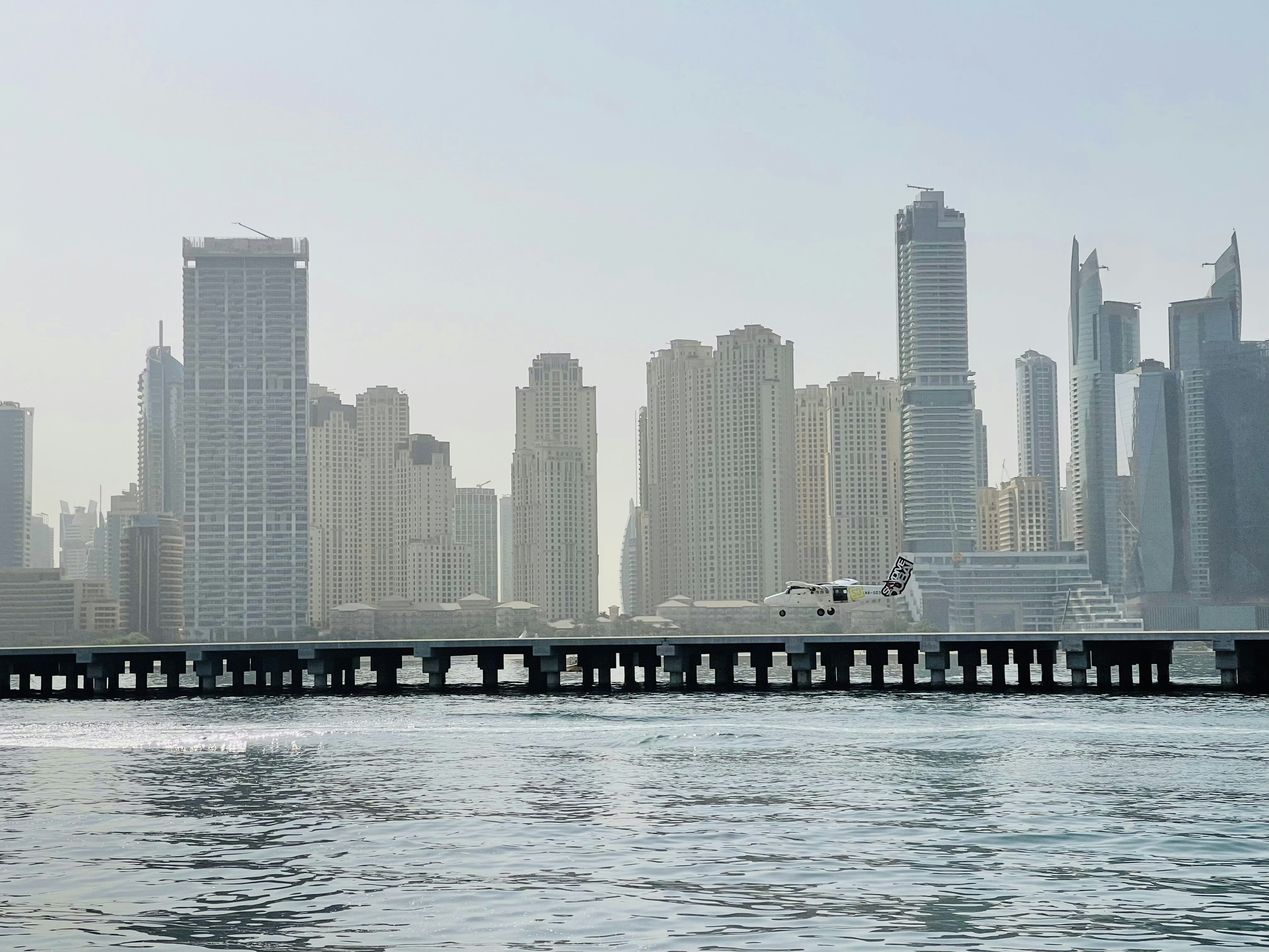 a large body of water with a city in the background, 