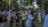 A group of diverse people planting trees in a park.