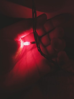 Close-up of the enlightenring on a forefinger, glowing softly against a serene background.