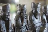 A rustic wooden chess set showing detailed handcrafted pieces.