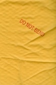 a piece of yellow paper with a red do not bed sticker on it