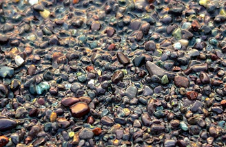 Close-up of smooth, washed epoxy stones glistening under natural light.