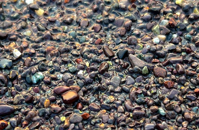 Close-up of smooth, washed epoxy stones glistening under natural light.