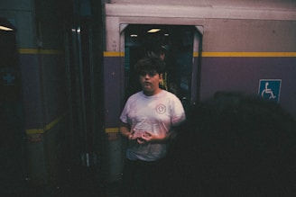 A smiling passenger holding a railcab ticket, ready to board.